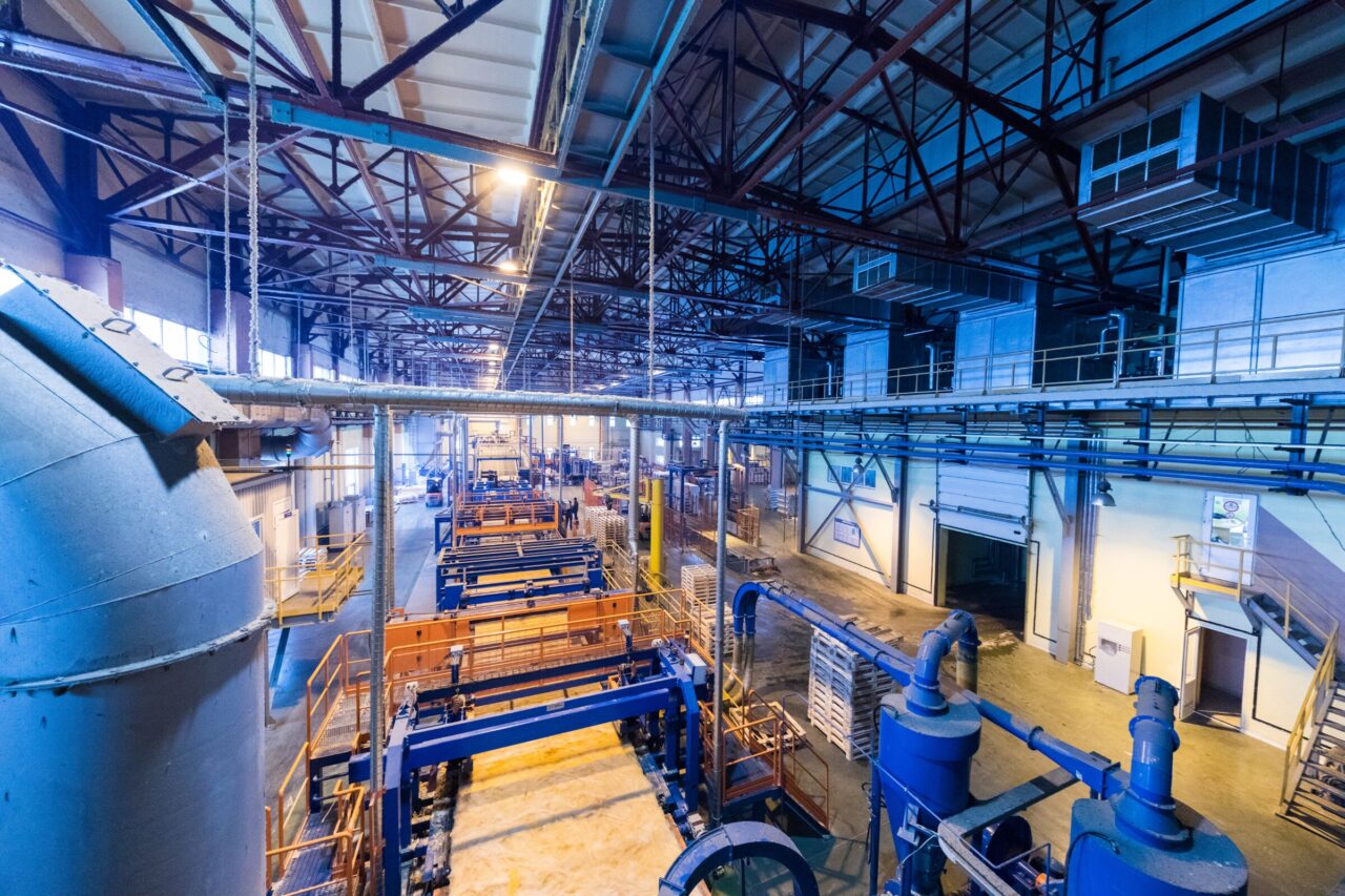 Interior of a large industrial manufacturing facility, representing multi-site EHS management, audits, permitting, and compliance support services.
