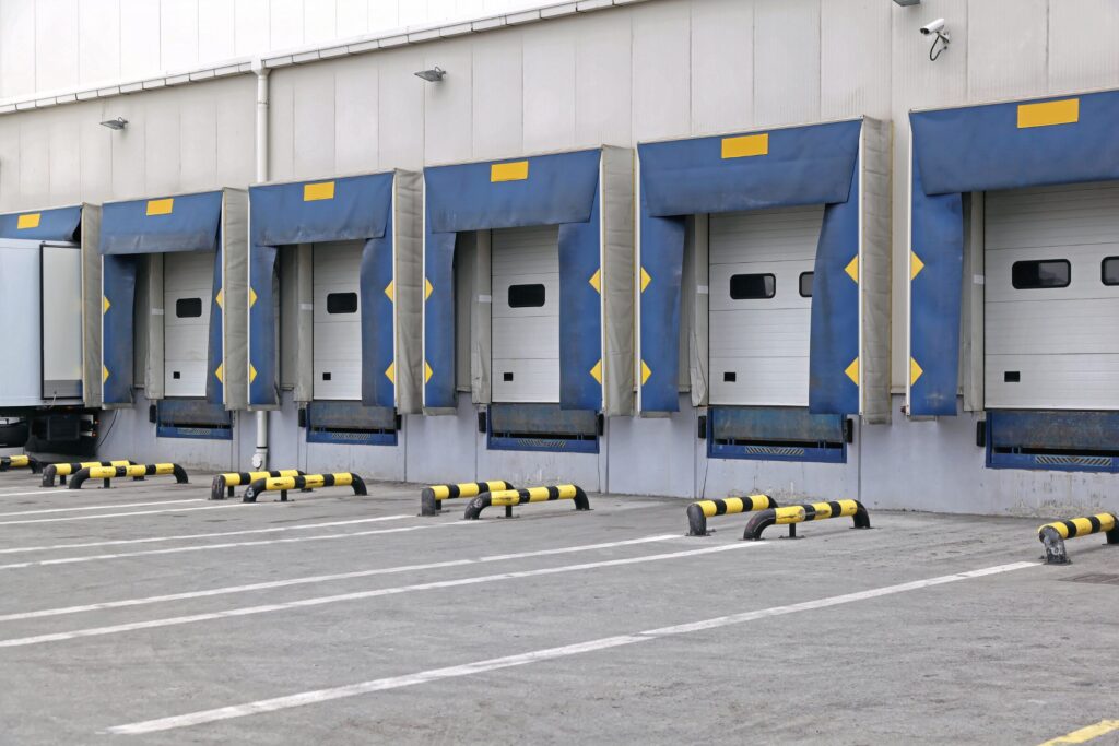 Covered industrial loading docks with weather-sealed doors to prevent stormwater exposure.